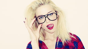 woman wearing black-framed eyeglasses and red lipstick
