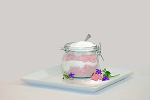 clear glass jar filled with white and pink sand