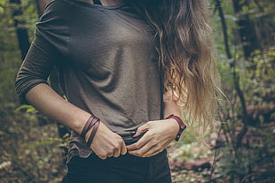 woman in black long-sleeved shirt wearing brown leather bracelet