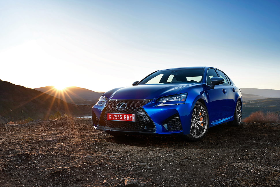 blue Lexus sedan on brown soil HD wallpaper