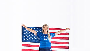 woman wears blue shirt holds U.S. flag