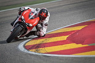 red and white sport bike on racing track HD wallpaper