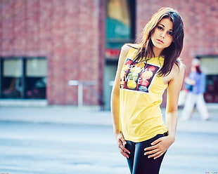 selective focus photo of woman wearing yellow tank top during daytiime