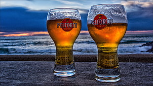 two Perfoth pint glasses near body of water