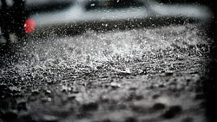 black and white concrete surface, depth of field, rain, water, puddle