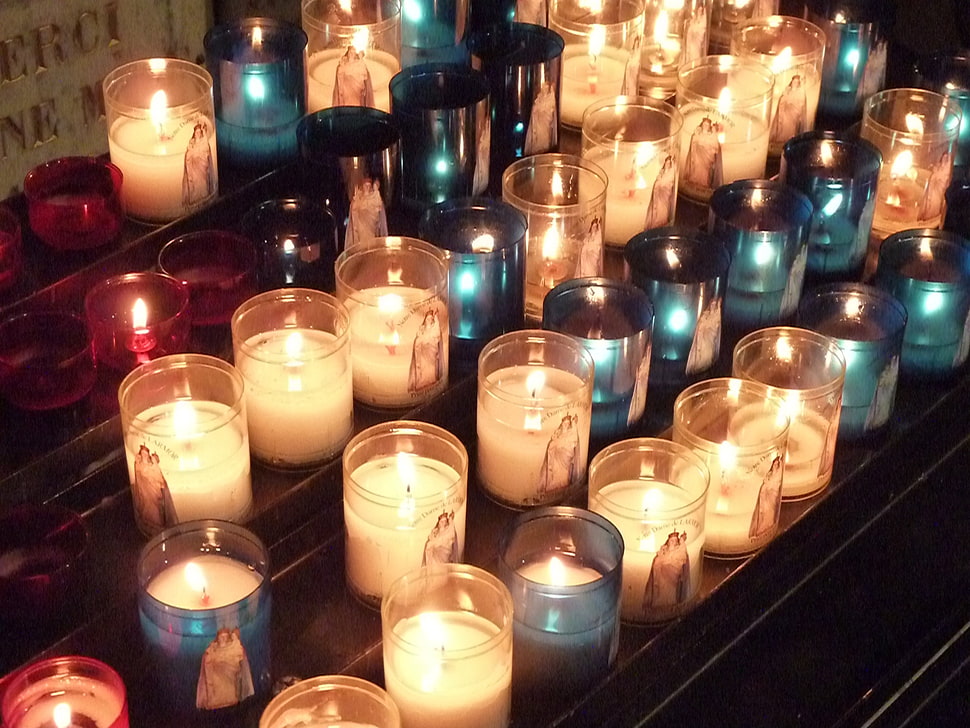 lighted votive candles on brown surface HD wallpaper