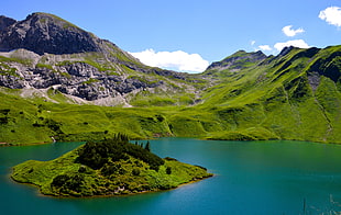 green mountain near lake
