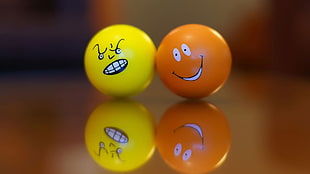yellow angry ball with orange smiling ball