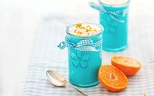 sliced orange beside on teal ceramic container