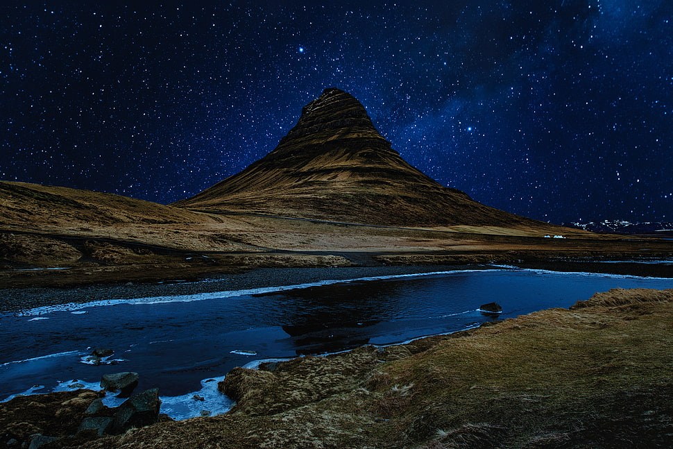 brown mountain under night sky HD wallpaper
