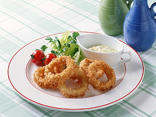 round white ceramic plate with Calamari, tomato and sauce