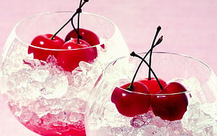 two wine glasses with cherry on top