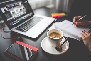 tilt shift photo of cup of coffee on black wooden tabletop HD wallpaper
