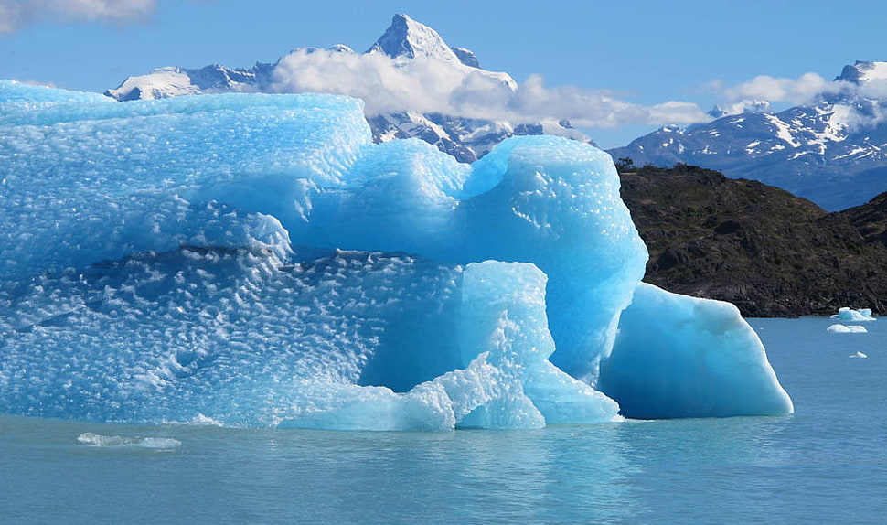 ice berg on the sea with mountain as background HD wallpaper