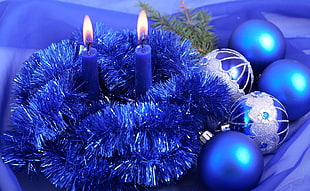 two blue candles  and blue tinsel