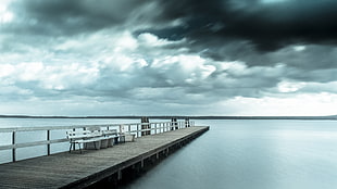 gray wooden docks at body of water under gray clouds HD wallpaper