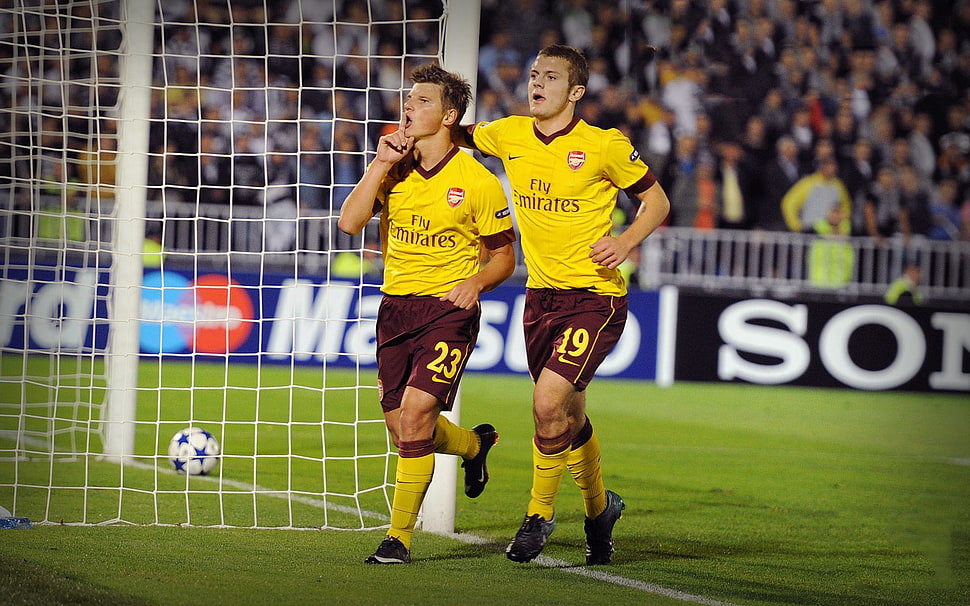 two Fly Emirates soccer player near goal HD wallpaper