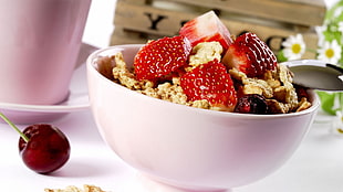 sliced strawberries and nuts in white bowl