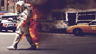 man wearing astronaut suit burning