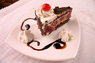 slice of chocolate cake with cherry on top