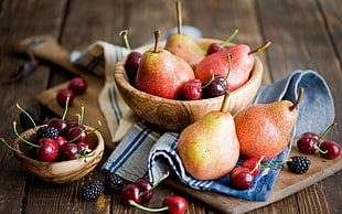 several pear fruits and red berries on brown wooden chopping board with bowl HD wallpaper