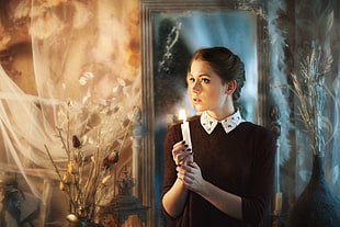 woman holding a candle