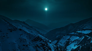 mountain range under night skies and full moon