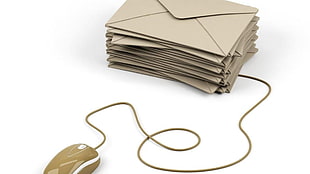 pile of brown envelopes beside gray corded mouse