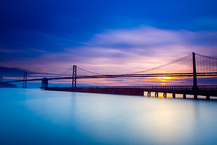 silhouette suspension bridge during sunset HD wallpaper