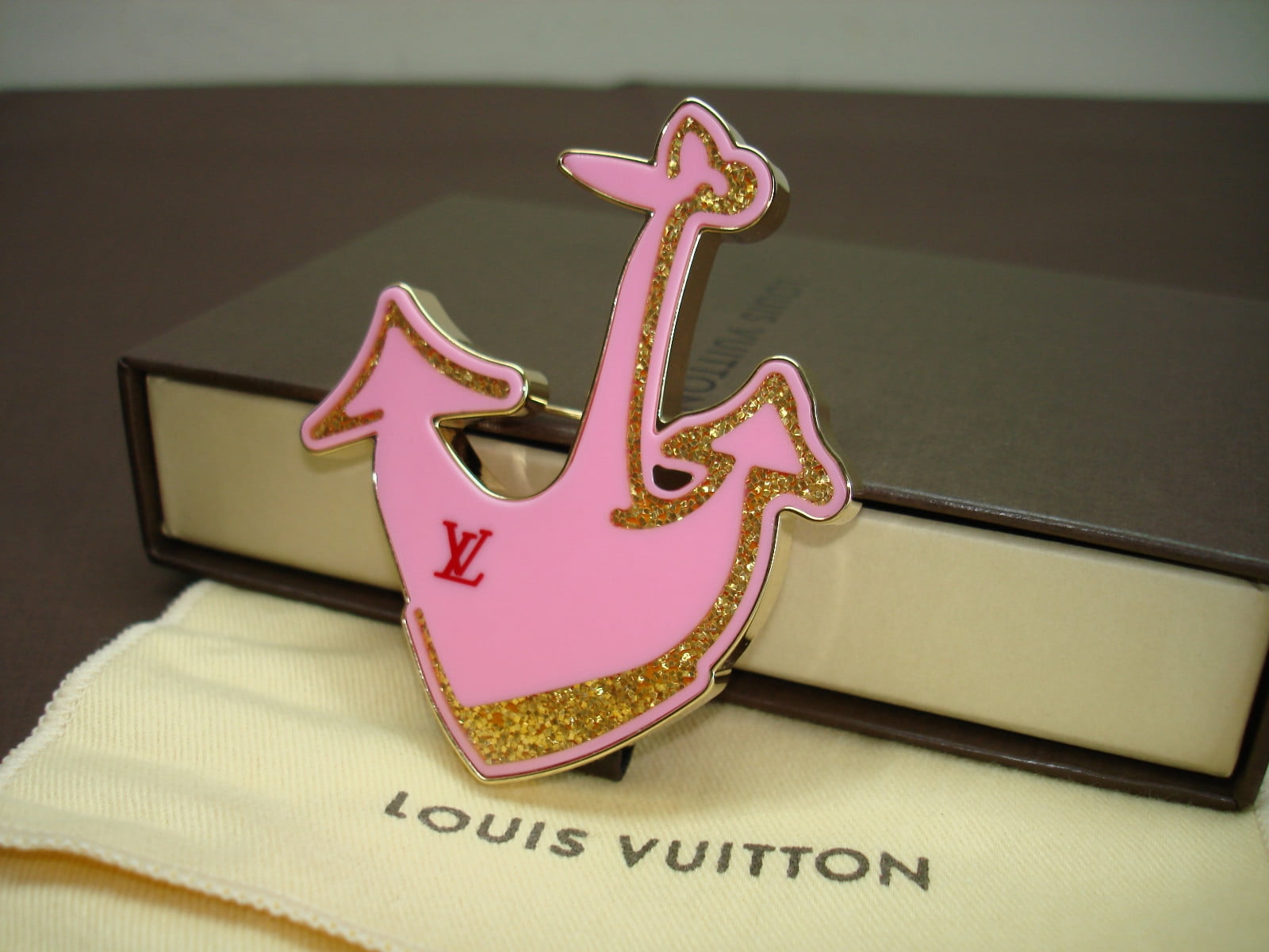 pink and gold Louis Vuitton emblem