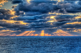 gray clouds on top of a body of water