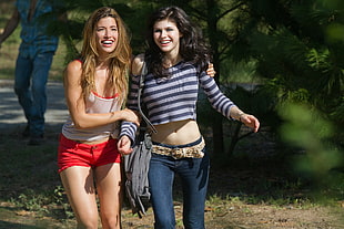 women wearing white and red tank top and gray-and-black striped long-sleeved shirt crop top