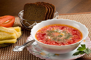 white ceramic bowl with red soup