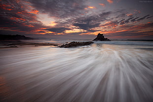 time lapse view of shore near rippling body of water