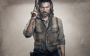 man wearing black vest holding gun poster HD wallpaper