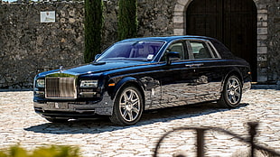 black Rolls Royce Phantom parked on concrete pavement during daytime