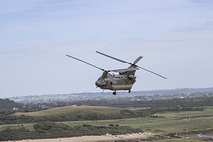 photography of helicopter flying in daytime