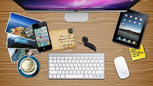 silver iMac, black iPad, and Apple wireless keyboard, and Magic mouse
