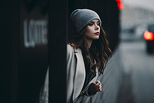 shallow focus photography of a woman in gray trench coat