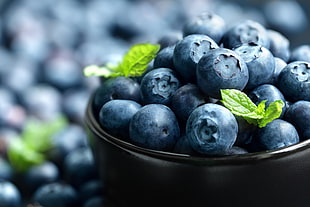 blueberries on black ceramic bowl