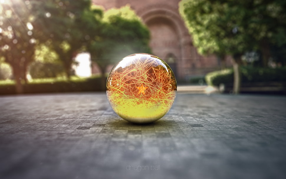 yellow and orange ball on grey concrete surface HD wallpaper