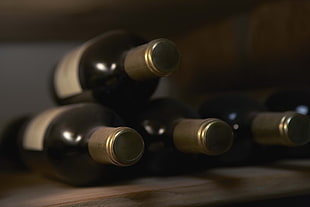 four wine bottles on table HD wallpaper
