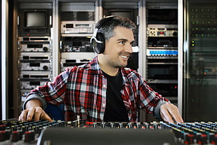 man with headphones using audio mixer