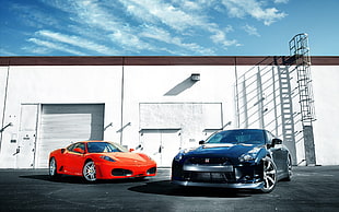 black Nissan GTR coupe and orange Ferrari sports car, car