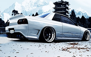 white coupe parked on gray pavement HD wallpaper