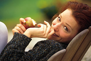 woman holding fruit smiling