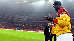 men's yellow polo shirt, Galatasaray S.K., soccer, praying