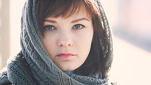 black haired woman in gray scarf portrait