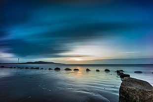 panoramic photo of sea under blue sky during sunrise HD wallpaper