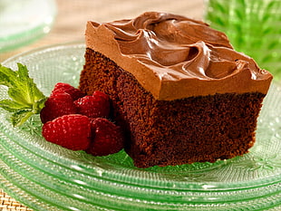 chocolate cake with strawberry on clear glass tray